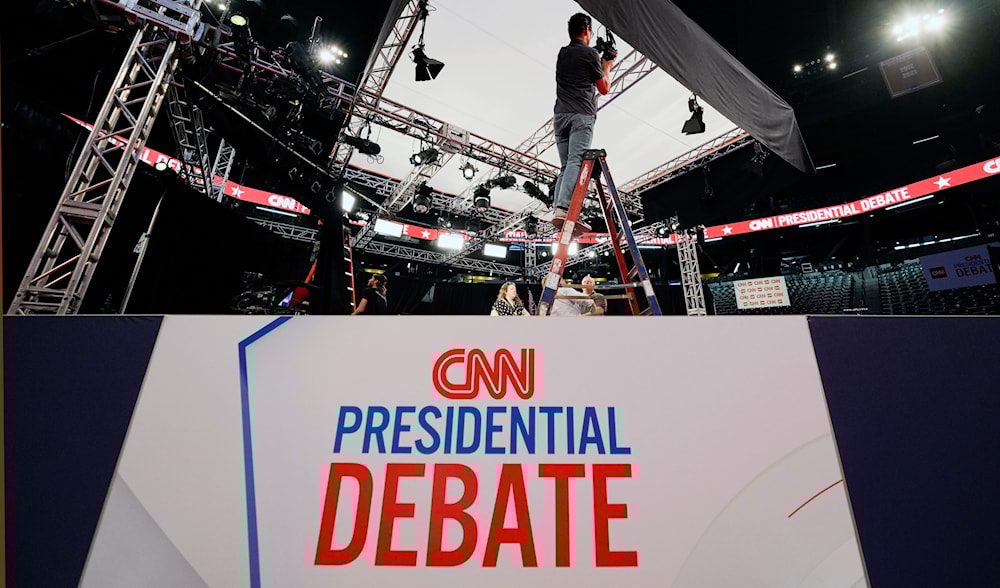 A lighting tech for CNN, sets up lights for the presidential debate between President Joe Biden and former President Donald Trump in Atlanta, Wednesday, June 26, 2024. (AP)