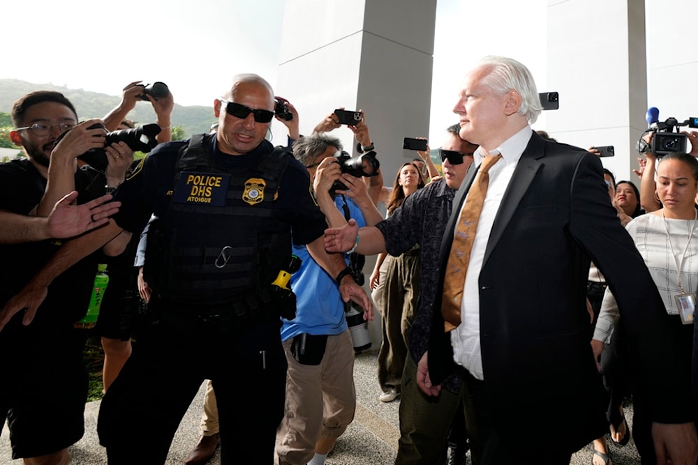 WikiLeaks founder Julian Assange, right, arrives, surrounded by the the media, at the United States courthouse where he is expected enter a plea deal, in Saipan, Mariana Islands, Wednesday, June 26 2024 (AP Photo/Eugene Hoshiko)