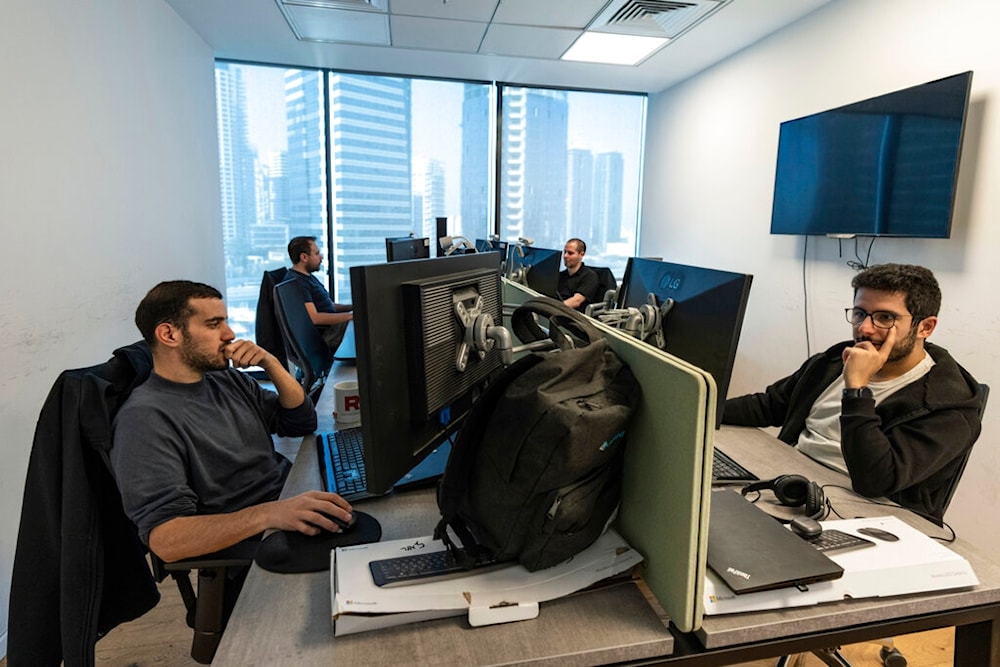 Employees of Pyramid Analytics hi-tech company work at their office in Ramat Gan, occupied Palestine, Wednesday, Jan. 18, 2023. (AP)