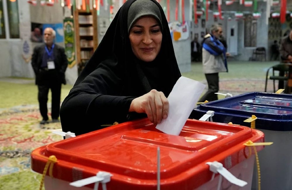 A woman casts her ballot during the parliamentary and Assembly of Experts elections at a polling station in Tehran, Iran, Friday, March 1, 2024. (AP)