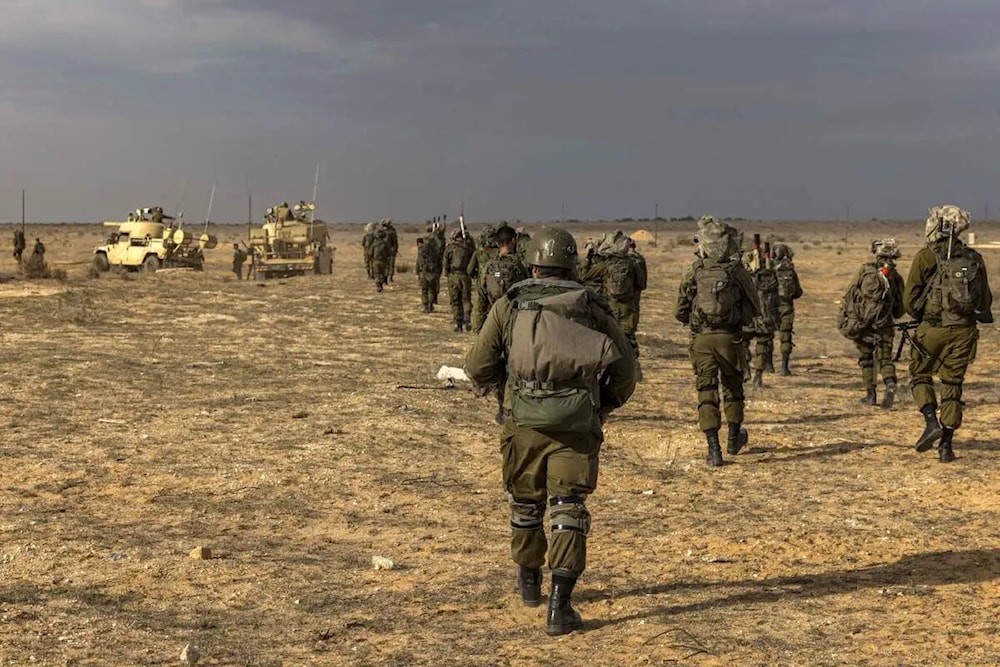 Israeli army soldiers walk ahead of a drill in the southern al-Naqab desert, “Israel”. (AFP via Getty Images)