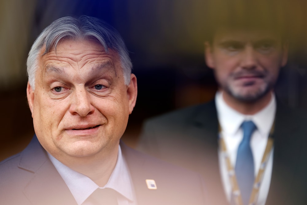 Hungary's Prime Minister Viktor Orban, left, arrives for an EU summit in Brussels, June 27, 2024. (AP)