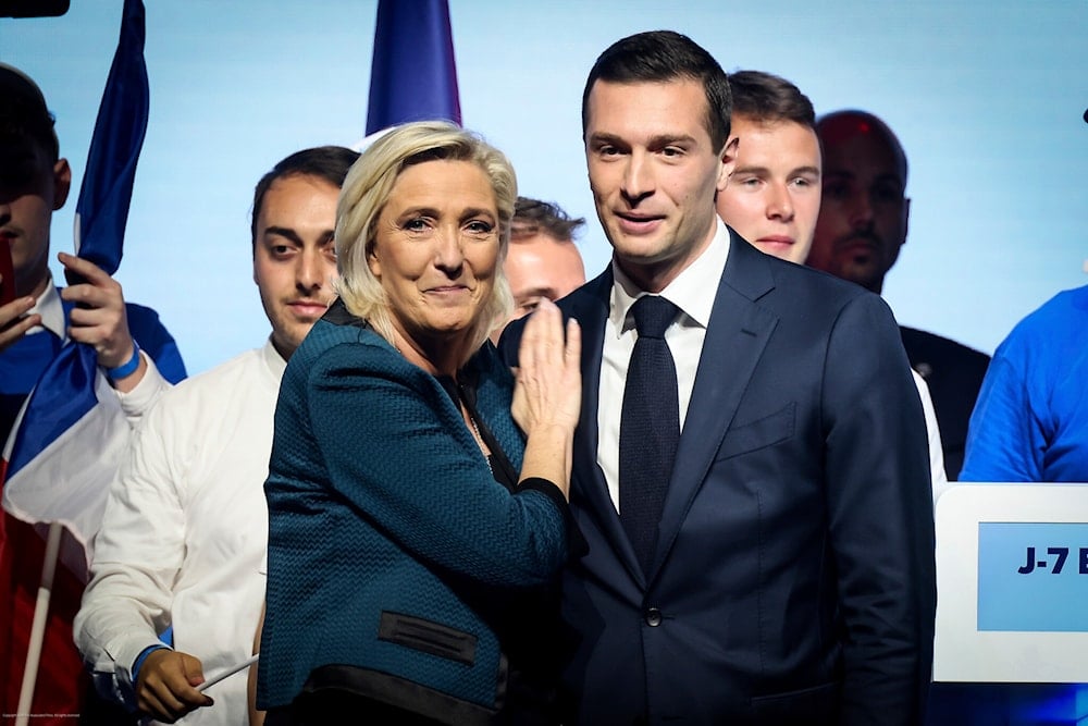 Leader of the French far-right National Rally Marine Le Pen, left, and lead candidate of the party for the upcoming European election Jordan Bardella during a political meeting on June 2, 2024 in Paris. (AP)