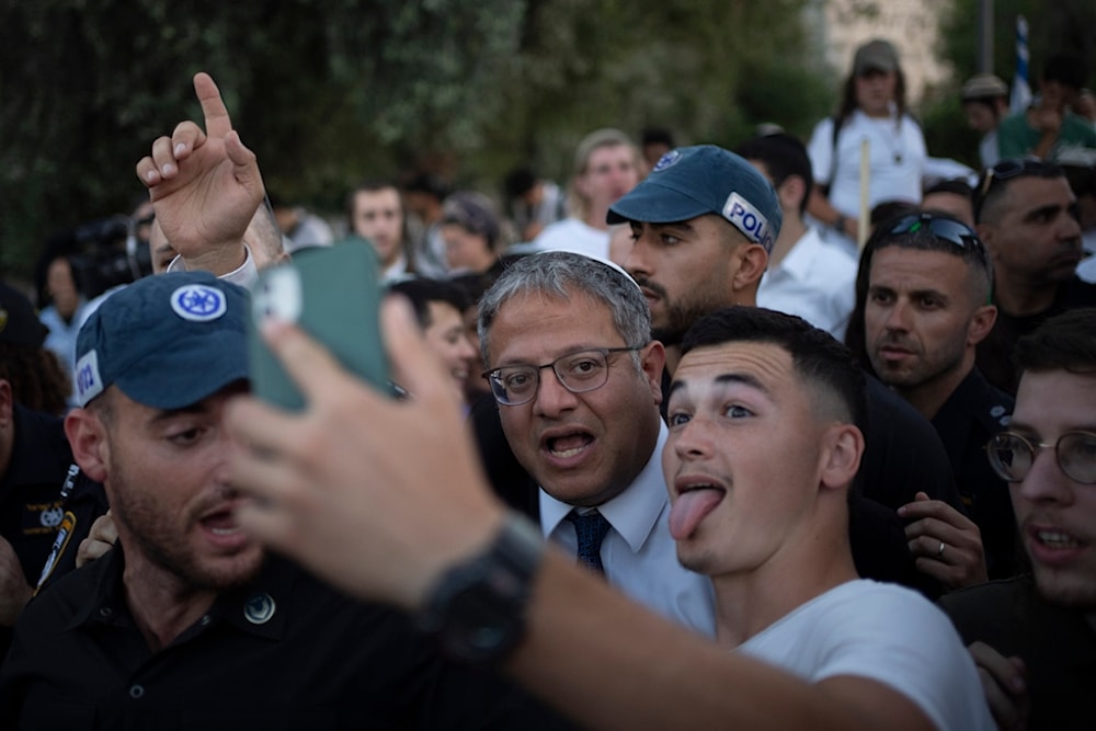 An Israeli settler takes a selfie with the Israeli occupation Police Minister Itamar Ben-Gvir, on Wednesday, June 5, 2024. (AP)