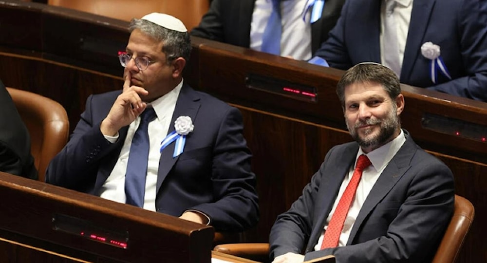 In this photo taken on November 15, 2022, then-Knesset members Itamar Ben-Gvir (L) and Bezalel Smotrich look on during the swearing-in ceremony for Israeli lawmakers in al-Quds. (AP)