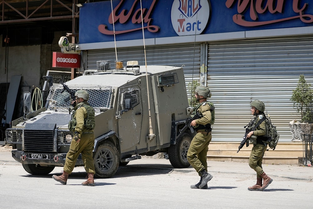 Israeli occupation officers walk back to their vehicles in the Palestinians al-Fara'a refugee camp in the occupied West Bank following an IOF military raid, Monday, June 10, 2024. (AP)