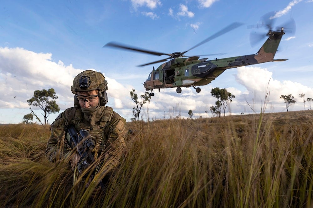 Australian troops dismount from an MRH-90 Taipan during Exercise Chau Pha at Townsville Field Training Area, Townsville, Queensland, on June 12, 2023 (AP)