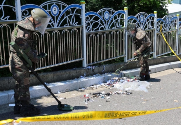 South Korean soldiers examine various objects including what appeared to be trash from a balloon believed to have been sent by DPRK, in Incheon, South Korea, on June 2, 2024. (YONHAP NEWS AGENCY)