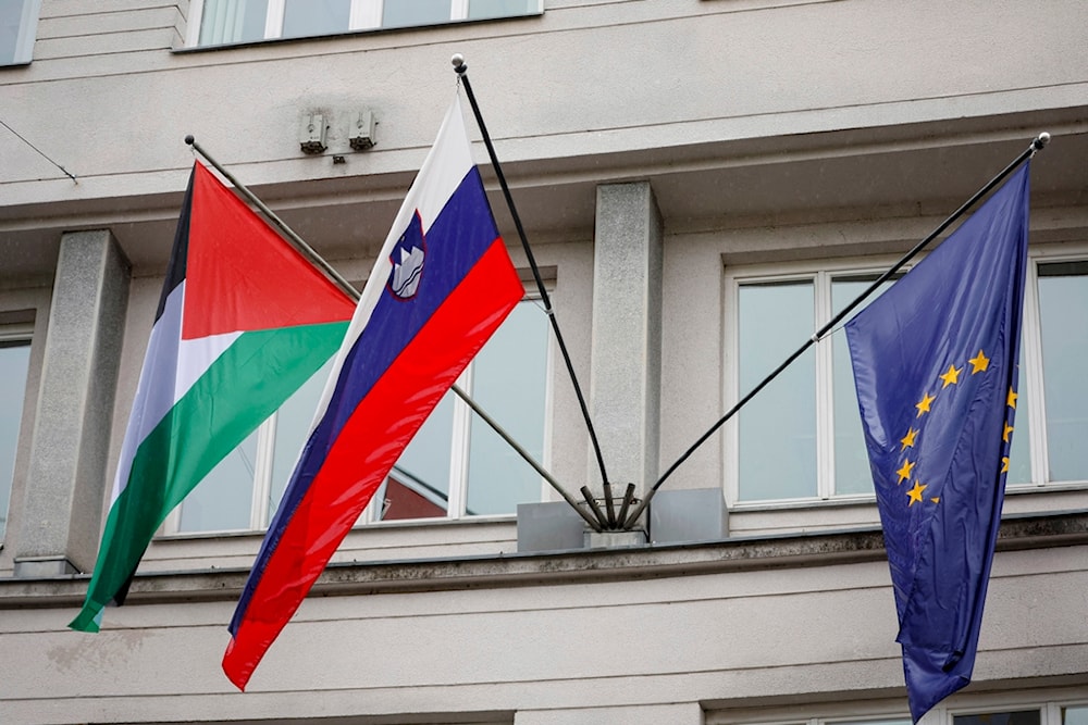 A Palestinian flag flies next to a Slovenian, center, and a European Union flag, right, at the government building in Ljubljana, Slovenia, Thursday, May 30, 2024 (AP)