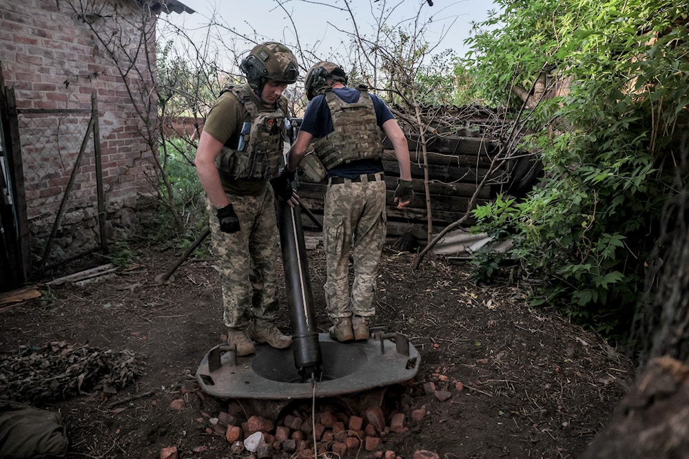 Ukrainian soldiers prepare to fire 120mm mortar towards Russian position on the front line at undisclosed location in Donetsk region, Ukraine, on June 4, 2024. (AP)