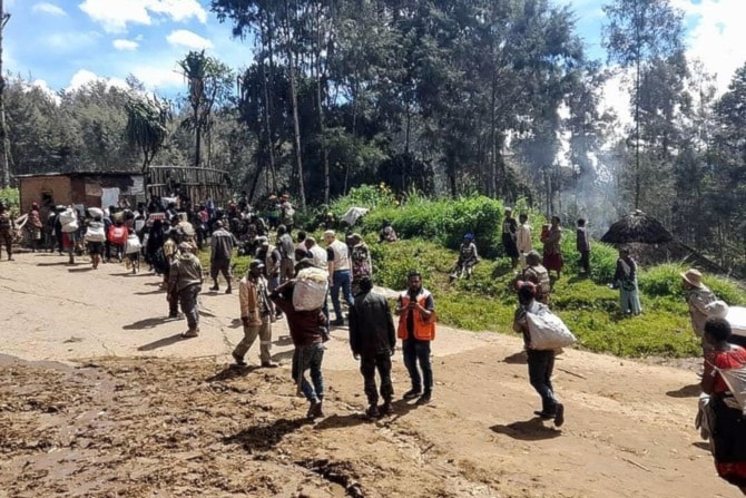 Above, locals carry supplies at the site of a landslide at Yambali village in the region of Maip Mulitaka, in Papua New Guinea’s Enga Province on May 29, 2024. (AFP)