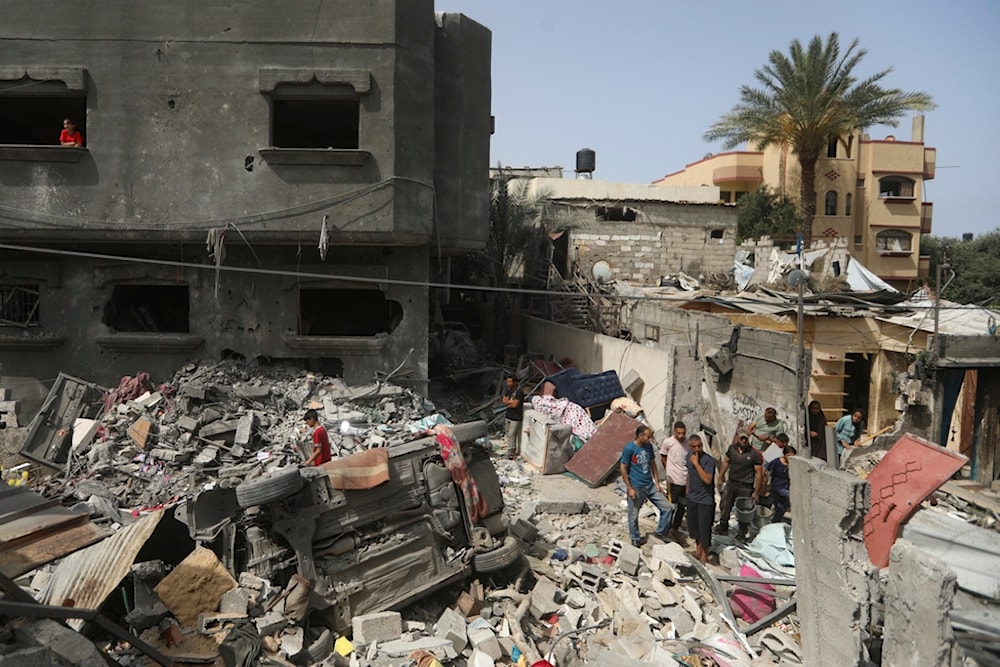 Palestinians look at the destruction after an Israeli strike on a residential building in Nuseirat Refugee Camp, Gaza Strip, Palestine, May 19, 2024. (AP)