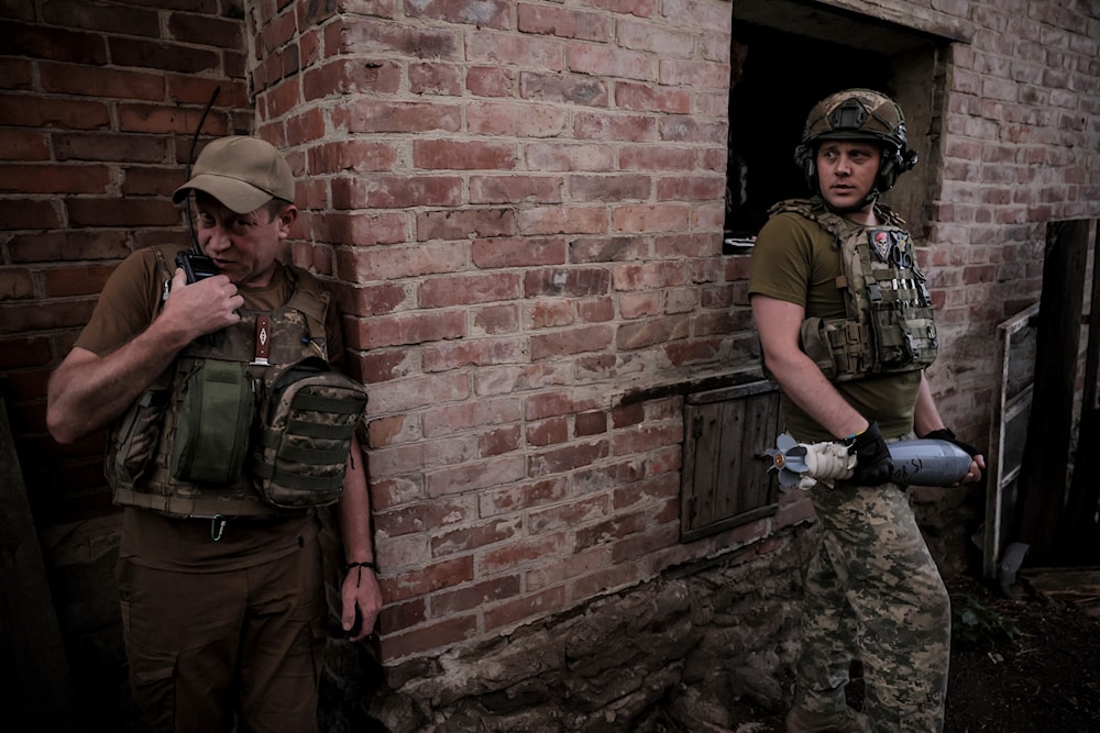 Ukrainian soldiers prepare to fire 120mm mortar towards Russian position on the front line at undisclosed location in Donetsk region, Monday, June 4, 2024 (Ukrainian 24 Mechanised brigade/AP)