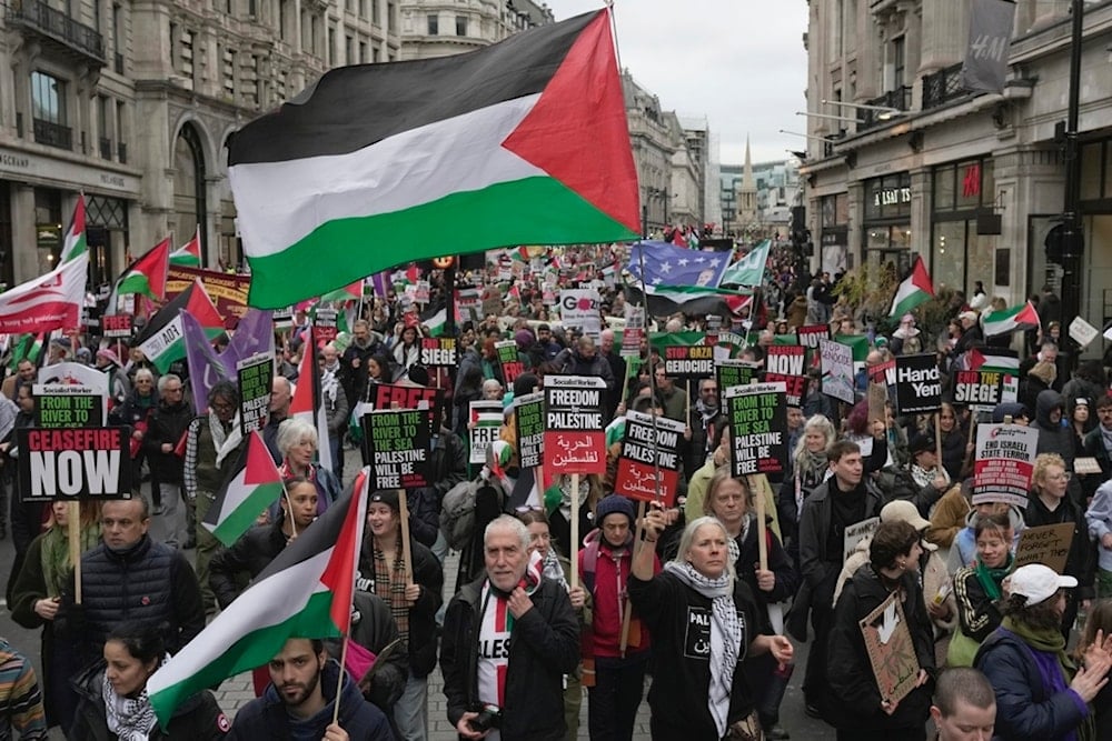 Pro-Palestinian protesters hold up banners, flags and placards during a demonstration in London, Saturday, Feb. 3, 2024 as they demand for a full cease fire and an end to the siege of Gaza. (AP)
