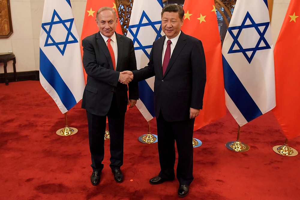 Israeli Prime Minister Benjamin Netanyahu and Chinese President Xi Jinping pose for photographers ahead of their talks at Diaoyutai State Guesthouse on March 21, 2017 in Beijing, China. (AP)
