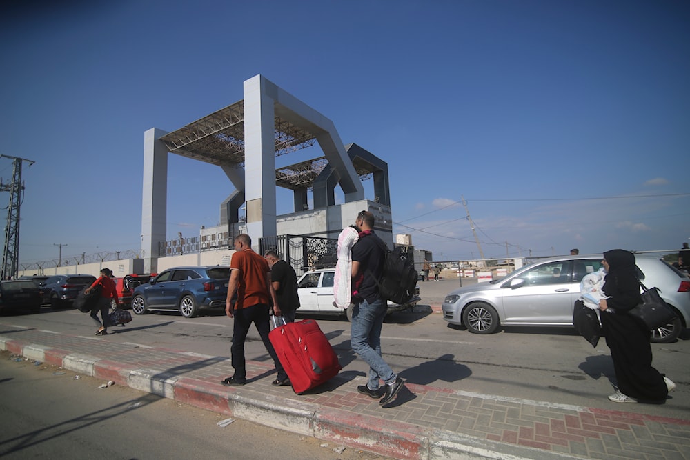 Palestinians wait to cross to the Egyptian side at Rafah border, Gaza Strip, on October 16, 2023. (AP)