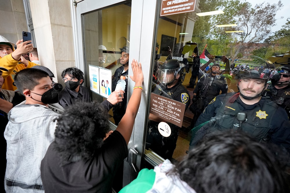 Police block Pro-Palestinian demonstrators from entering a building on the UCLA campus, May 23, 2024, in Los Angeles, the United States (AP)