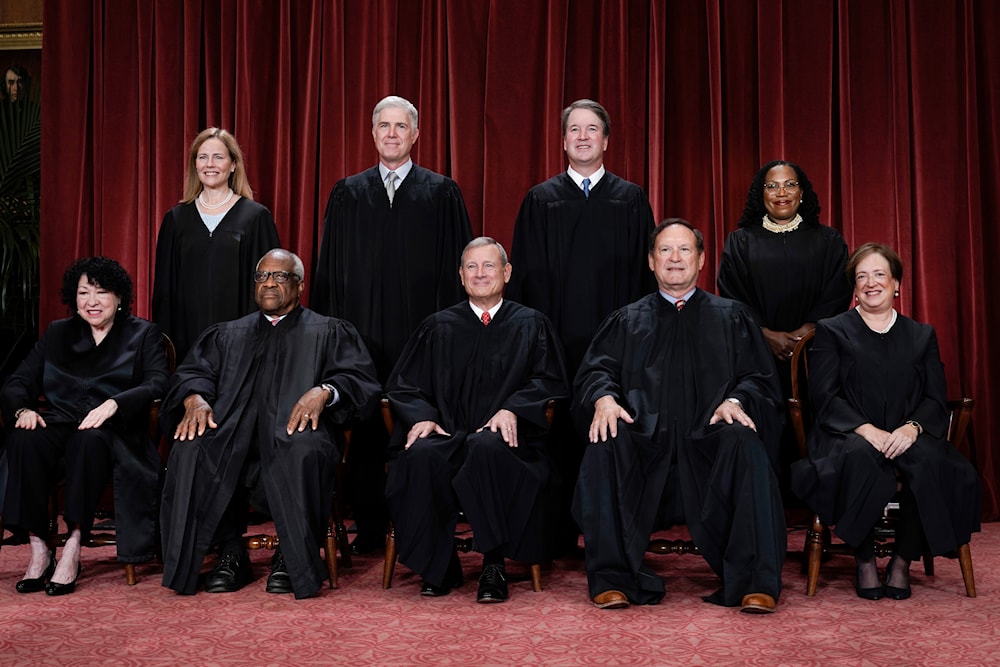 Members of the Supreme Court sit for a new group portrait following the addition of Associate Justice Ketanji Brown Jackson, at the Supreme Court building in Washington, the United States, October 7, 2022 (AP)