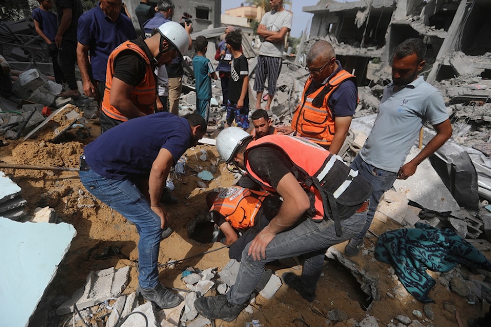 Palestinians search for survivors after an Israeli airstrike on a residential building in Nuseirat Refugee Camp, Gaza Strip, Palestine, May 19, 2024. (AP)