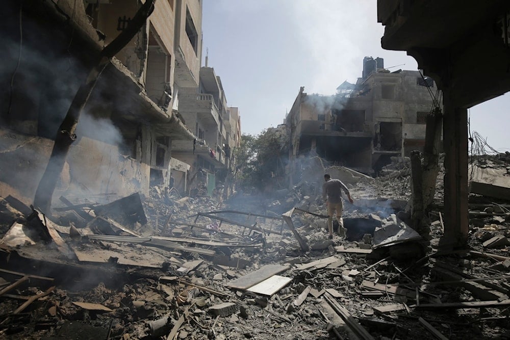 Palestinians look at the aftermath of the Israeli bombing in Nuseirat refugee camp, Gaza Strip, Saturday, June 8, 2024 (AP Photo/Jehad Alshrafi)