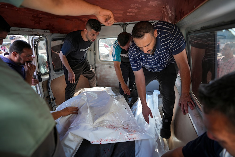Palestinians bring people killed in the Israeli bombardment of the Gaza Strip to a hospital in Deir al Balah, the Gaza Strip, occupied Palestine, June 7, 2024 (AP)
