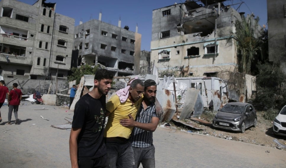 Palestinians help a wounded man after Israeli strikes in Nuseirat refugee camp, Gaza Strip, Saturday, June 8, 2024. (AP)