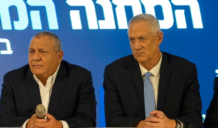 Gadi Eisenkot, left, Benny Gantz, right, sit together for Eisenkot's announcement of his election bid and their alliance in Ramat Gan, occupied Palestine, Sunday, Aug. 14, 2022 (AP)