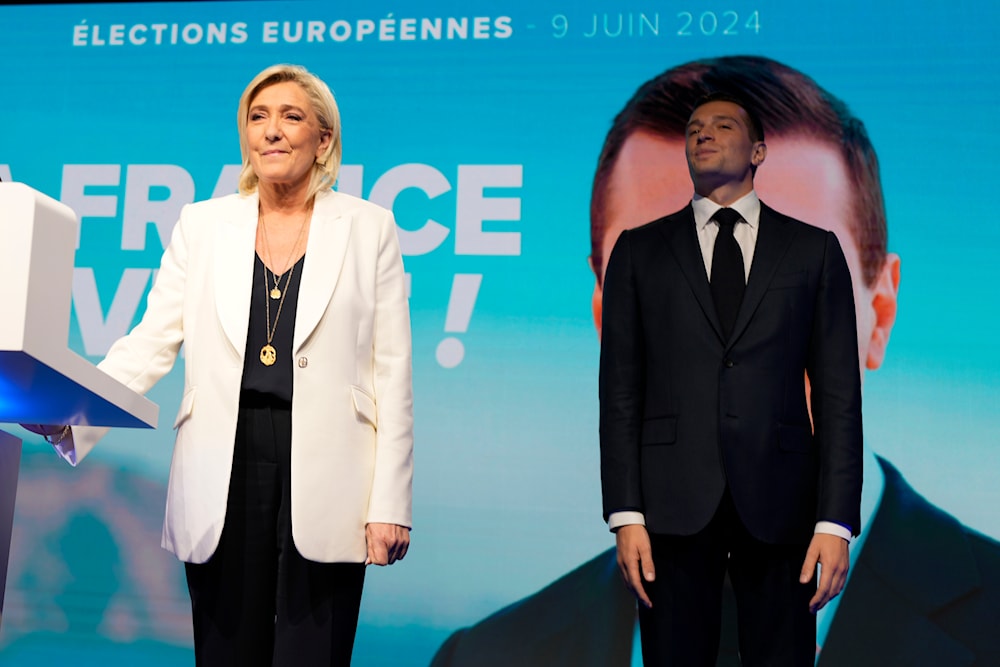 French far-right leader Marine Le Pen and Jordan Bardella, president of the French far-right National Rally, stand at the party election night headquarters, Sunday, June 9, 2024 in Paris (AP)