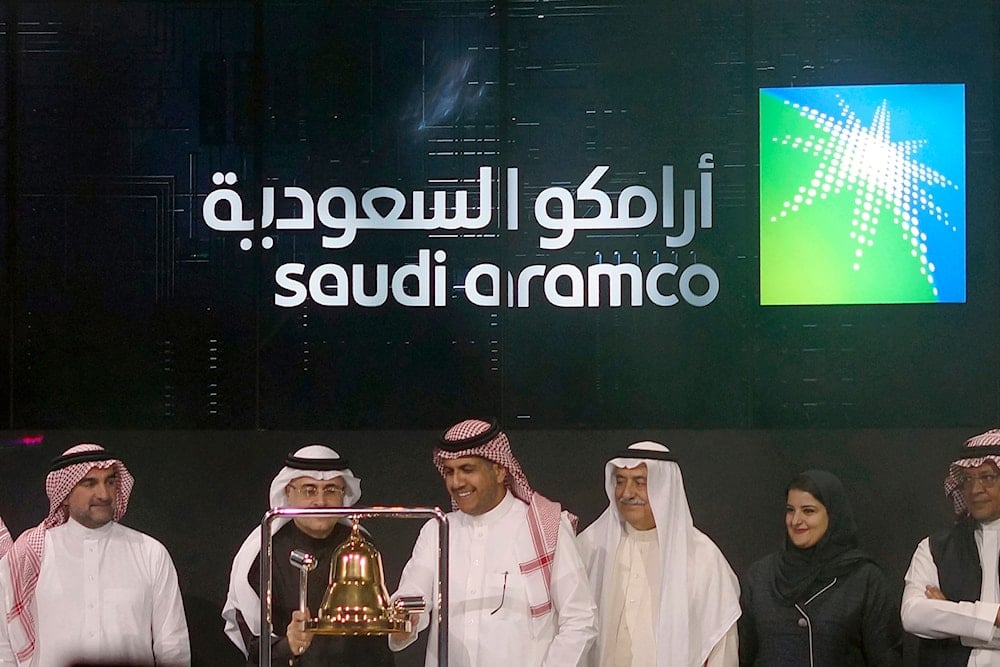 Saudi Arabia's state-owned oil company Aramco and stock market officials celebrate the debut of Aramco's initial public offering on the Riyadh Stock Market in Saudi Arabia, Dec. 11, 2019. (AP)