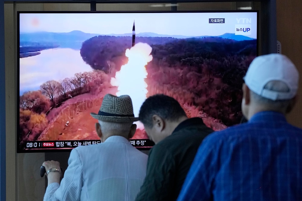 People watch a news program broadcasting a file image of a missile launch by DPRK, at Seoul Railway Station in Seoul, South Korea, Wednesday, June 26, 2024. (AP)