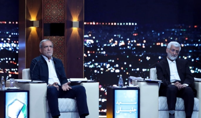 Masoud Pezeshkian, center, speaks in a debate of the candidates as Saeed Jalili listens at the TV studio in Tehran, Iran, Monday, June 17, 2024. (Morteza Fakhri Nezhad/IRIB via AP)