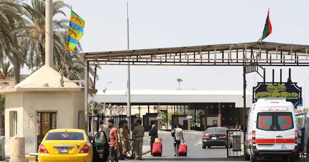 Vehicles cross from Libya into Tunisia at Ras Ajdir border crossing in 2021. AFP