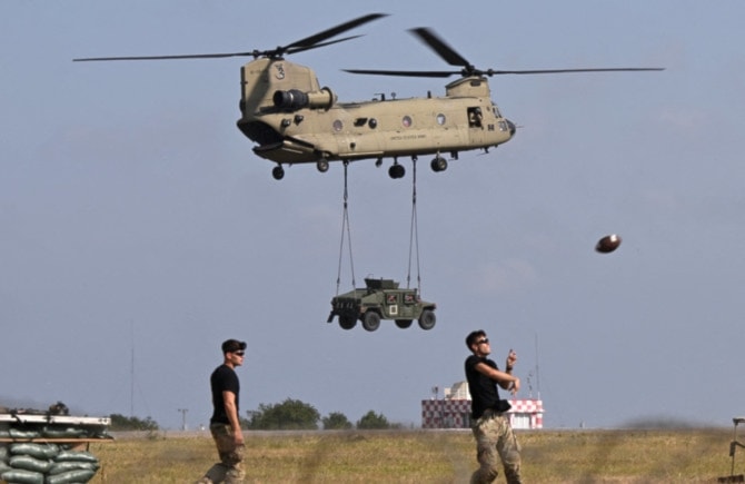 American troops take part in a NATO demonstration drill at Mihail Kogalniceanu Airbase near Constanta, Romania. The US military has raised the alert level of several bases in Europe to its second-highest level on June 30, 2024. ((AFP)