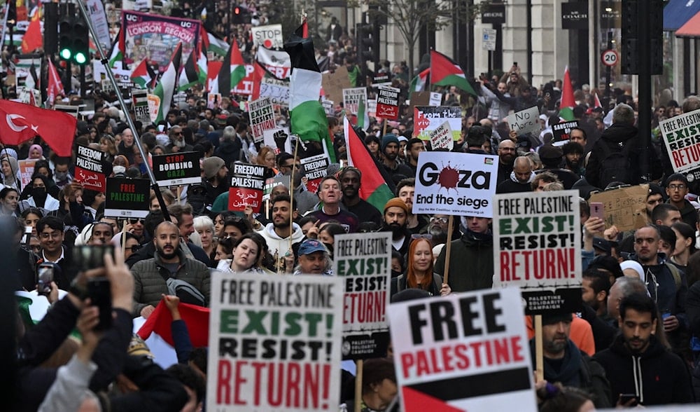 People walk down Regent Street as they take part in a 'March For Palestine' in London on October 14, 2023. (AFP)