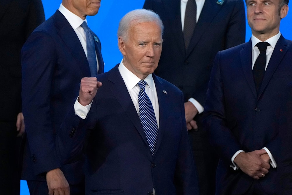 President Joe Biden pumps his fist as he poses with NATO leaders for an official photo at the NATO summit in Washington, July 10, 2024 (AP)