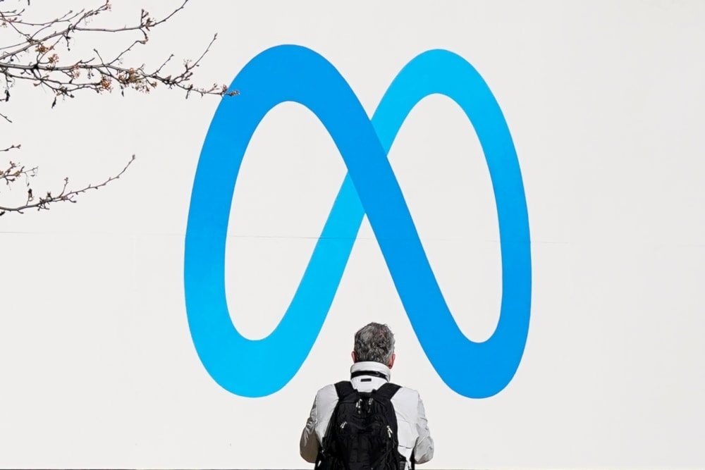 A person stands in front of a Meta sign outside of the company’s headquarters in California, United States, Tuesday, March 7,2023. (AP)