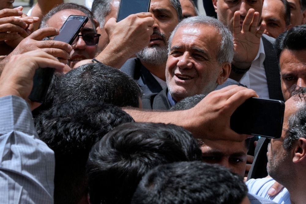 Iranian presidential candidate Masoud Pezeshkian is greeted by his supporters as he arrives to vote at a polling station in Tehran on July 5,2024. (AP)