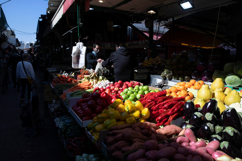 Israeli shop at a market in 'Tel Aviv', occupied Palestine, on February 21, 2021. (AP)