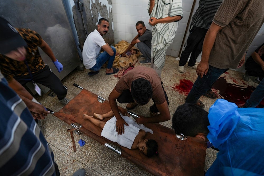 Palestinians mourn their relatives killed in the Israeli bombardment of the Gaza Strip in a hospital in Deir al Balah on June 16, 2024. (AP)