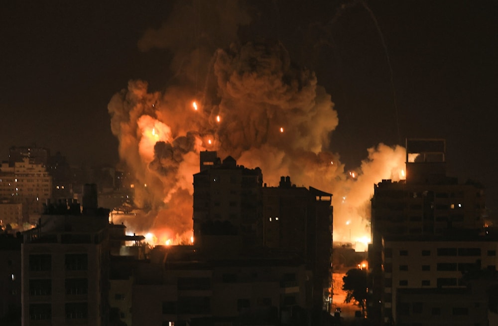 Fire and smoke rise above residential buildings in Gaza City during an Israeli airstrike on October 8, 2023 (AFP)