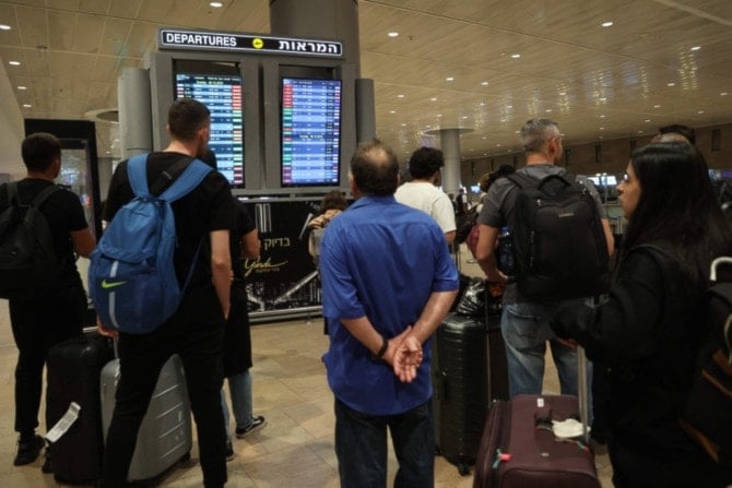 Passengers wait at Israeli occupation Ben Gurion Airport near Tel Aviv, on October 7, 2023, as flights are canceled because of Operation al-Aqsa Flood. (AFP)