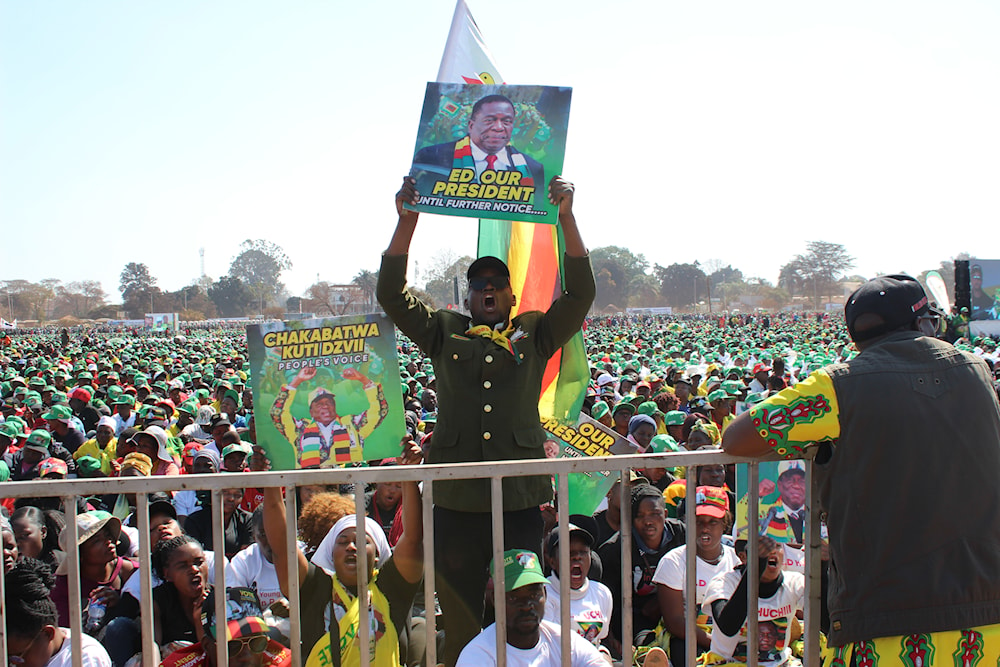 A supporter of Zimbabwean President Emmerson Mnangagwa holds the Zimbabwean flag at a campaign rally in Harare, on August 9, 2023. (AP)