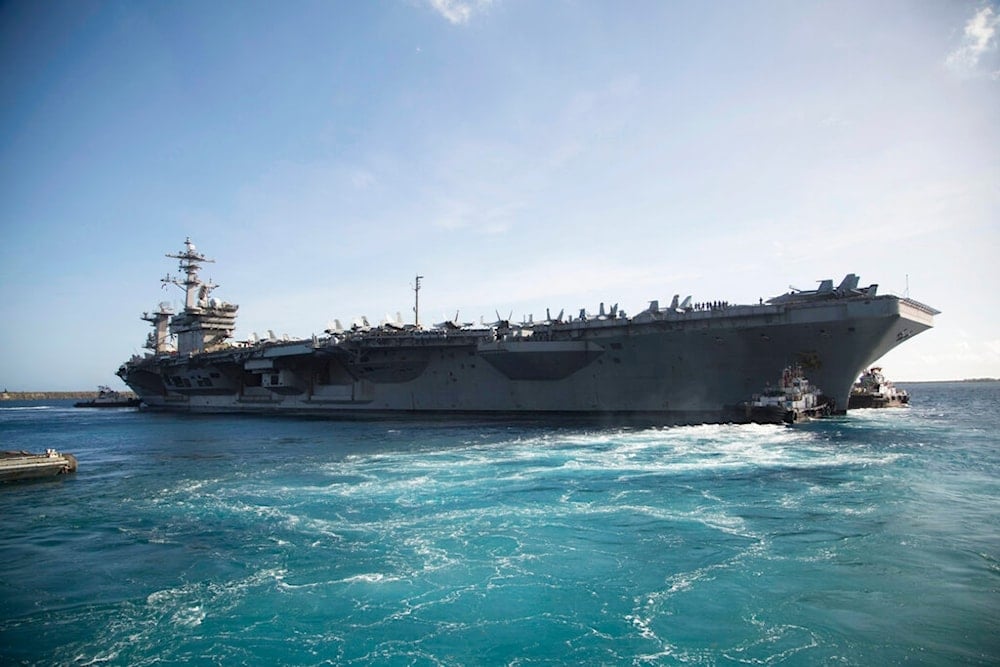 In this photo provided by the U.S. Marine Corps, the aircraft carrier USS Theodore Roosevelt (CVN 71) departs Apra Harbor at Naval Base Guam on Thursday, May 21, 2020. (US Marine Corps via AP)