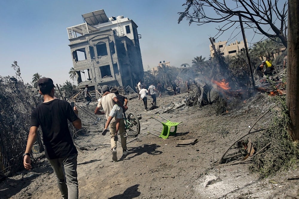 Palestinians evacuate from a site hit by an Israeli bombardment on Khan Younis, southern Gaza Strip, Saturday, July 13, 2024. (AP)