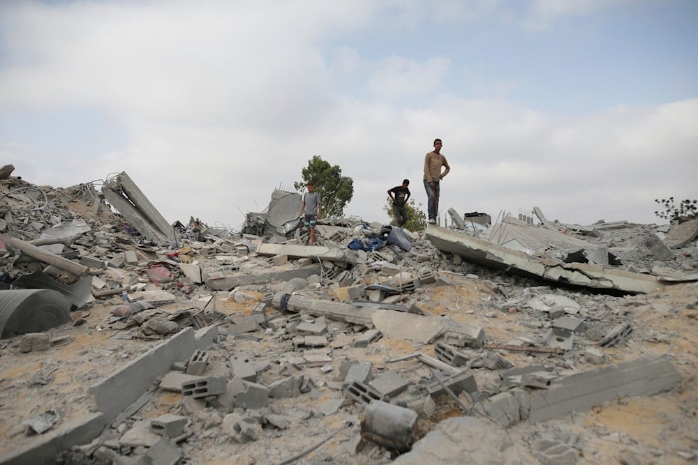 Palestinians look at the destruction after an Israeli airstrike in Khan Younis, Gaza Strip, occupied Palestine, June 3, 2024 (AP)