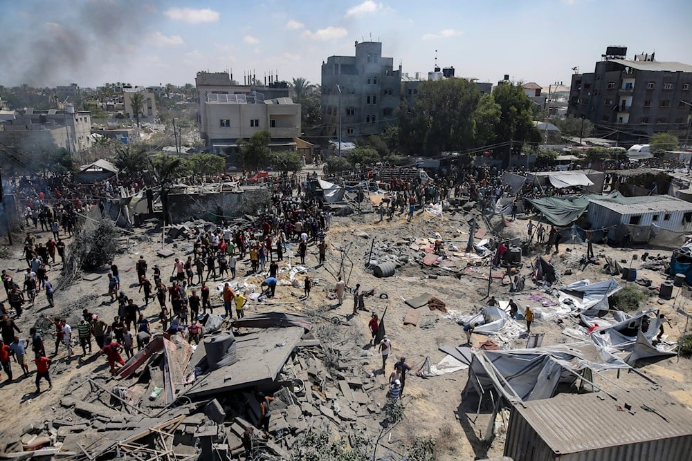 Palestinians inspect the damage at a site hit by an Israeli bombardment on Khan Younis, southern Gaza Strip, occupied Palestine, July 13, 2024