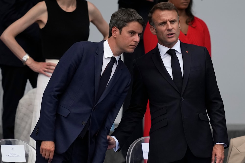 French President Emmanuel Macron, right, and French Prime Minister Gabriel Attal attend the Bastille Day parade Sunday, July 14, 2024 in Paris. (AP)