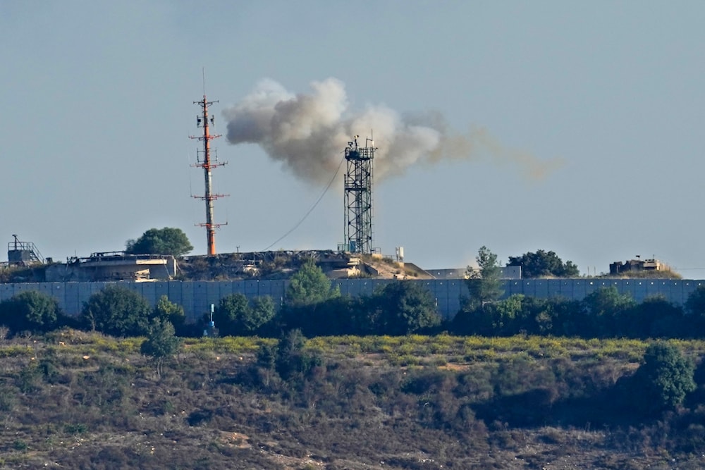 Smoke rises from inside an Israeli military site which was hit by Hezbollah as seen from Tair Harfa village, south Lebanon, October 20, 2023 (AP)