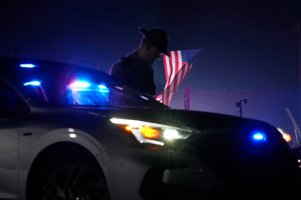 An officer stands at his car early Sunday, July 14, 2024, closing access to the site of the rally where former President Donald Trump was the target of an assassination attempt. (AP)