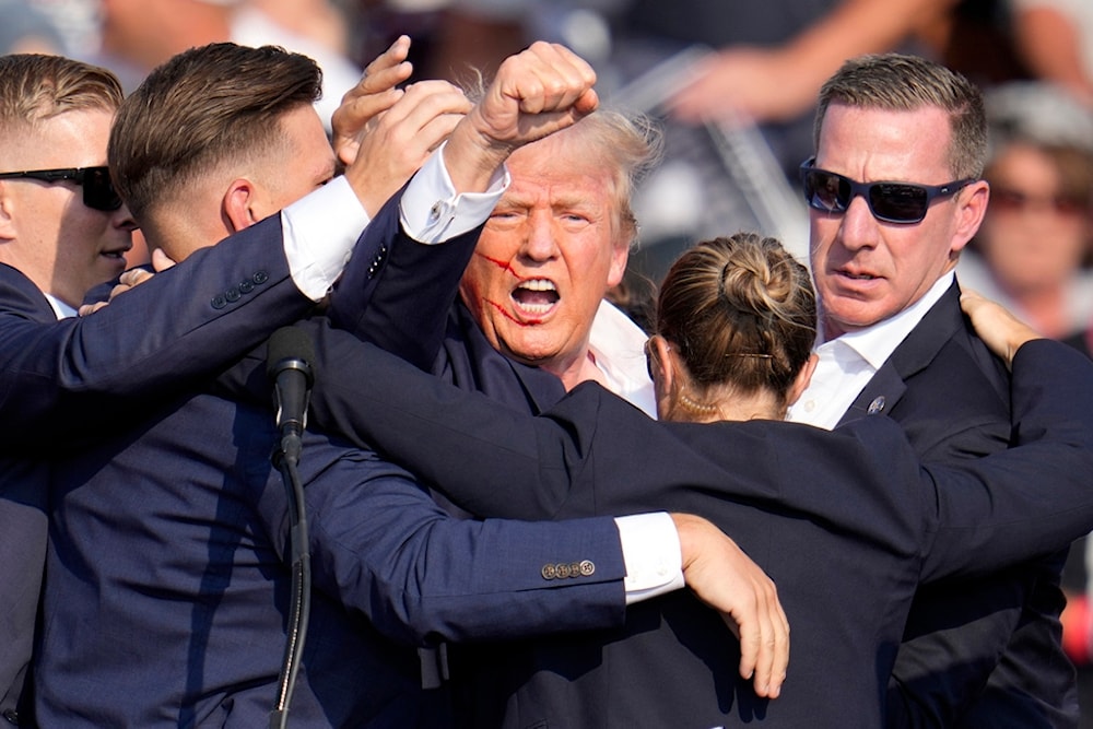 Republican presidential candidate former President Donald Trump is helped off the stage by U.S. Secret Service agents at a campaign event in Butler, Pa., on Saturday, July 13, 2024. (AP)